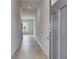 Inviting hallway with grey laminate flooring and fresh neutral paint at 305 Heavenly Hollow Pl, Mcdonough, GA 30253