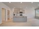 Modern kitchen featuring an island, stainless steel appliances, and neutral paint at 305 Heavenly Hollow Pl, Mcdonough, GA 30253