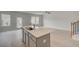 Bright open living space with a kitchen island and light wood flooring at 305 Heavenly Hollow Pl, Mcdonough, GA 30253
