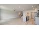 Open-concept living space with light wood floors, ceiling fan, and kitchen island at 305 Heavenly Hollow Pl, Mcdonough, GA 30253