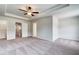Spacious main bedroom featuring neutral walls, carpet flooring, ceiling fan, and tray ceiling at 305 Heavenly Hollow Pl, Mcdonough, GA 30253