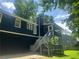 Backyard view highlighting deck access to the screened porch on a sunny day at 4790 Brandon Acres Ln, Buford, GA 30519