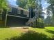 View of backyard with screened porch, deck, chimney, and paver patio at 4790 Brandon Acres Ln, Buford, GA 30519