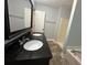 Bathroom with dual sinks, black granite countertop, tub, and a separate walk-in shower at 4790 Brandon Acres Ln, Buford, GA 30519