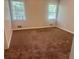 This light filled bedroom features neutral paint and carpeting at 4790 Brandon Acres Ln, Buford, GA 30519