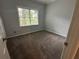 Bright bedroom with neutral walls, plush carpet, and a window with natural light at 4790 Brandon Acres Ln, Buford, GA 30519