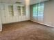 Spacious bonus room with built-in shelving and storage and a window for natural light at 4790 Brandon Acres Ln, Buford, GA 30519