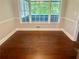 Cozy dining area bathed in natural light with wainscoting and hardwood floors at 4790 Brandon Acres Ln, Buford, GA 30519