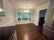 Dining room with hardwood floors, large window and stylish chandelier, perfect for entertaining at 4790 Brandon Acres Ln, Buford, GA 30519