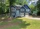 Charming two-story home featuring a blue exterior, complemented by a spacious front yard and a convenient two-car garage at 4790 Brandon Acres Ln, Buford, GA 30519