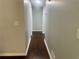 Hallway featuring hardwood flooring and neutral paint, providing seamless flow throughout the home at 4790 Brandon Acres Ln, Buford, GA 30519
