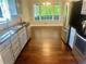 Updated kitchen with stainless steel appliances, granite countertops, and a sun-filled dining area at 4790 Brandon Acres Ln, Buford, GA 30519