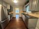Updated kitchen featuring stainless steel appliances, gray cabinets, and hardwood floors at 4790 Brandon Acres Ln, Buford, GA 30519