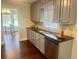 Charming kitchen with gray cabinets, granite countertops, and stainless steel dishwasher at 4790 Brandon Acres Ln, Buford, GA 30519