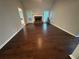 Inviting living room with hardwood floors and a cozy stone fireplace, perfect for relaxation at 4790 Brandon Acres Ln, Buford, GA 30519