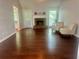 Inviting living room with hardwood floors, a stone fireplace, and two comfortable armchairs for relaxation at 4790 Brandon Acres Ln, Buford, GA 30519