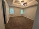 Spacious main bedroom featuring tray ceiling, neutral carpet, and windows with natural light at 4790 Brandon Acres Ln, Buford, GA 30519