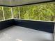 Enjoy the outdoors in this spacious screened porch with views of the lush, mature backyard at 4790 Brandon Acres Ln, Buford, GA 30519