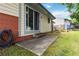 Patio with concrete stairs provides access to the yard, with lush grass and mature trees creating a peaceful outdoor space at 5791 Cobbrook Dr, Ellenwood, GA 30294