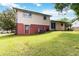 Expansive backyard featuring a well-maintained lawn and a two-story home with a red-brick foundation at 5791 Cobbrook Dr, Ellenwood, GA 30294