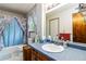 Bright bathroom with a large mirror, a single sink, and a shower/tub at 5791 Cobbrook Dr, Ellenwood, GA 30294