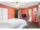 Bedroom featuring neutral colors, a ceiling fan, and multiple entryways at 5791 Cobbrook Dr, Ellenwood, GA 30294