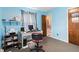 Bright bedroom with blue walls, large windows, and an office area at 5791 Cobbrook Dr, Ellenwood, GA 30294