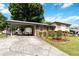 A home with a carport and a well maintained lawn and roses at 5791 Cobbrook Dr, Ellenwood, GA 30294