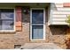 A close-up view of the home's front door with brick facade and decorative shutters at 5791 Cobbrook Dr, Ellenwood, GA 30294