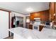 A kitchen with wood cabinets and marble countertops featuring an easy access back door at 5791 Cobbrook Dr, Ellenwood, GA 30294