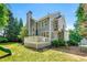 Backyard view of a two-story house with a deck, privacy fence, and lush green lawn at 1265 Timberline Pl, Alpharetta, GA 30005