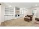 Basement area with built-in shelving, plush carpeting, and a comfortable seating area at 1265 Timberline Pl, Alpharetta, GA 30005