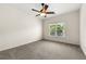 Carpeted bedroom featuring a ceiling fan and a window with natural light at 1265 Timberline Pl, Alpharetta, GA 30005