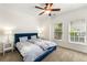 Bedroom with neutral carpet, a blue upholstered bed, and bright natural light at 1265 Timberline Pl, Alpharetta, GA 30005