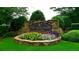 Stone community entrance sign with colorful flower bed at 'The Highlands at Park Bridge' subdivision at 1265 Timberline Pl, Alpharetta, GA 30005