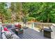 Relaxing deck featuring comfortable seating, outdoor decor, and views of a private wooded backyard at 1265 Timberline Pl, Alpharetta, GA 30005