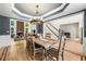 Elegant dining room with hardwood floors, a modern chandelier, and access to living room and views of the fireplace at 1265 Timberline Pl, Alpharetta, GA 30005