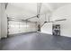 Spacious garage with painted floor, high ceilings and storage; perfect for parking and hobbies at 1265 Timberline Pl, Alpharetta, GA 30005