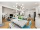 Bright kitchen with modern light fixture, white cabinets, and an island with seating open to the living room at 1265 Timberline Pl, Alpharetta, GA 30005