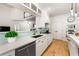 Modern kitchen featuring white cabinets, stainless steel appliances, quartz countertops and a stylish backsplash at 1265 Timberline Pl, Alpharetta, GA 30005