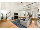 Bright, open living room with hardwood floors, high ceilings, and staircase leading to a second-floor balcony at 1265 Timberline Pl, Alpharetta, GA 30005
