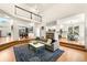 Spacious living room with open layout to kitchen and dining area, featuring hardwood floors and ample natural light at 1265 Timberline Pl, Alpharetta, GA 30005