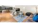Cozy living room featuring hardwood floors, neutral paint, and view of dining room, with a comfortable sofa and stylish decor at 1265 Timberline Pl, Alpharetta, GA 30005