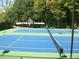Outdoor tennis court with green and blue surface and a surrounding fence at 1265 Timberline Pl, Alpharetta, GA 30005