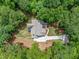Aerial view of a home showcasing its layout, roofing, and beautiful surrounding landscape at 2585 Hickory Rd, Canton, GA 30115