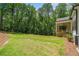 Lush, green backyard with wooden porch, large yard, and mature trees at 2585 Hickory Rd, Canton, GA 30115