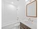 Bathroom features a shower-tub combo, dark wood vanity, and white marble countertop at 2585 Hickory Rd, Canton, GA 30115