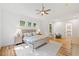 Sunlit bedroom with a ceiling fan, hardwood floors, and an adjacent walk-in closet at 2585 Hickory Rd, Canton, GA 30115