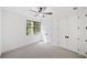 Bright bedroom with neutral carpet and paint, ceiling fan, large closet, and window with a view at 2585 Hickory Rd, Canton, GA 30115