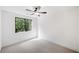 Bright bedroom features carpet flooring and a window with wooded view at 2585 Hickory Rd, Canton, GA 30115